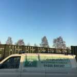 works van next to a row of shipping containers