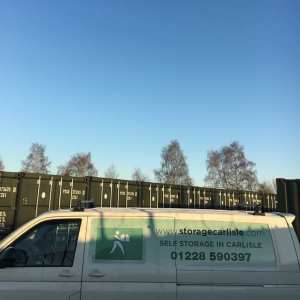 works van next to a row of shipping containers