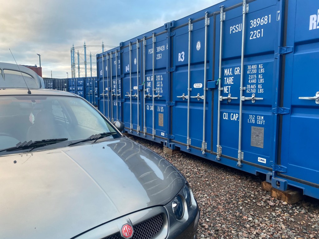 car unloading into a shipping container on a self storage facility