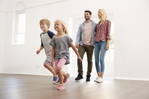 family opening the front door of their new home in Cumbria