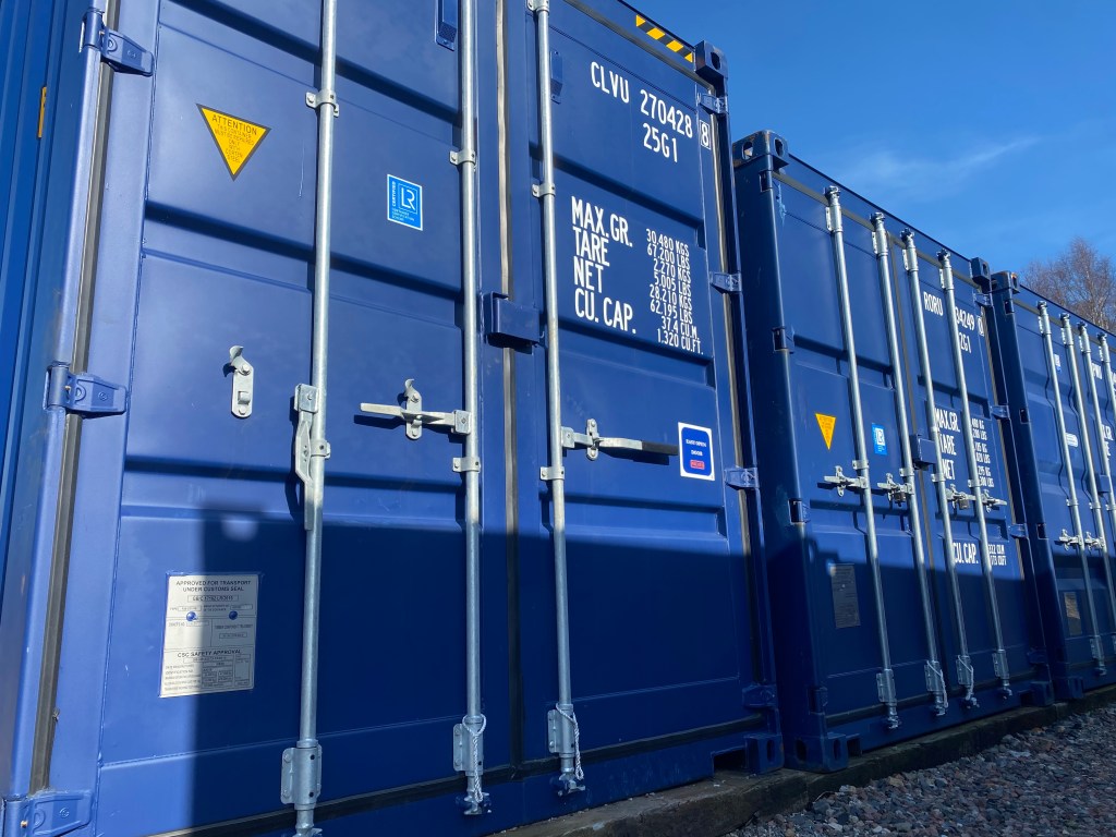 a row of immaculate shipping containers used for furniture storage