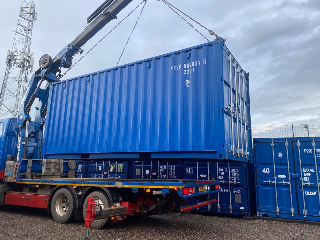 a large shipping container on the back of a lorry