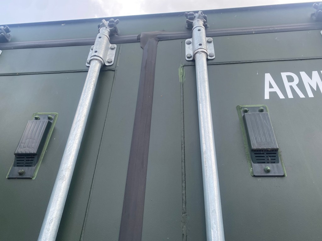 close up of the top of a shipping container showing air vents on it