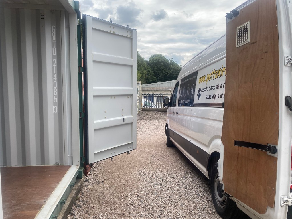 unloading goods into a shipping container