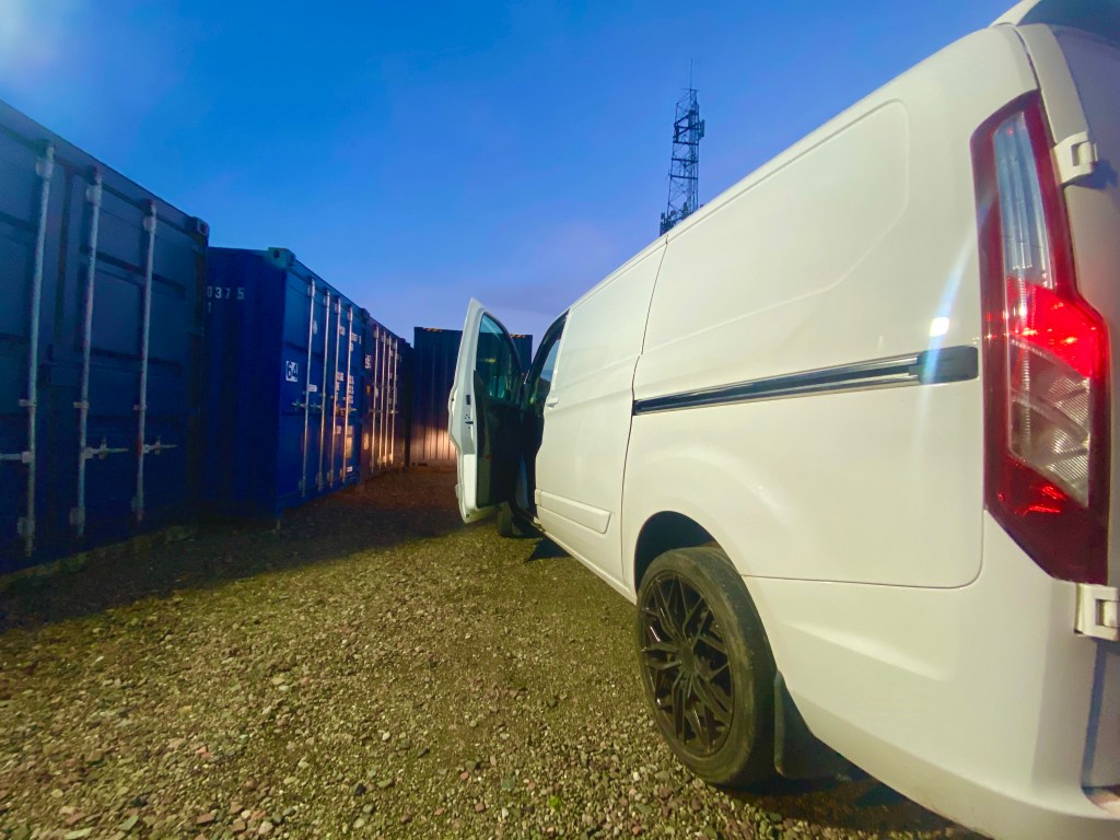 van unloading at dusk on a storage facility
