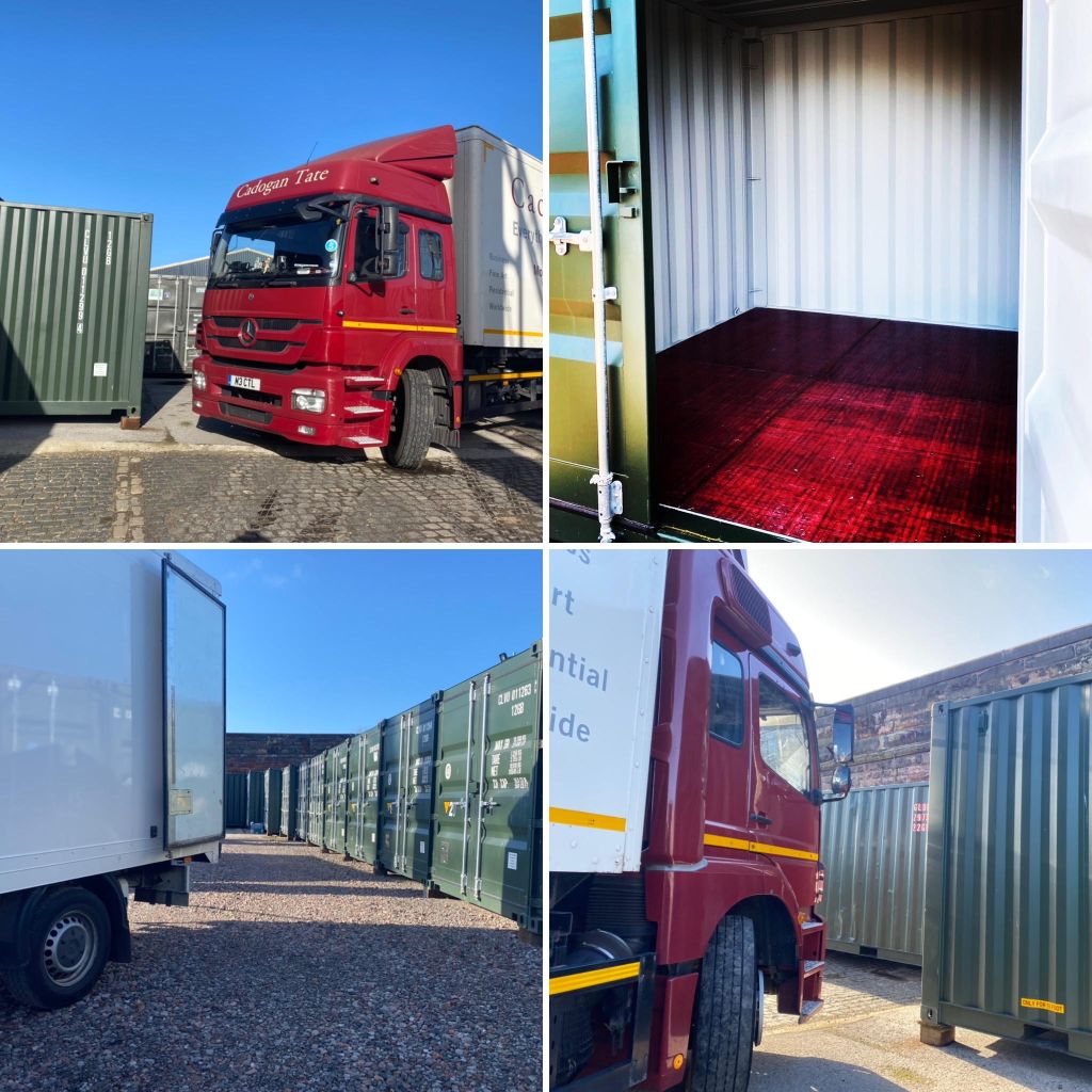 A red truck parked next to green shipping container storage units in an outdoor storage facility.