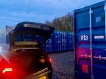 car unloading goods into a shipping container