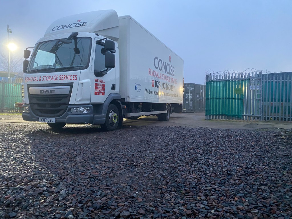 a removals lorry unloading on a storage facility