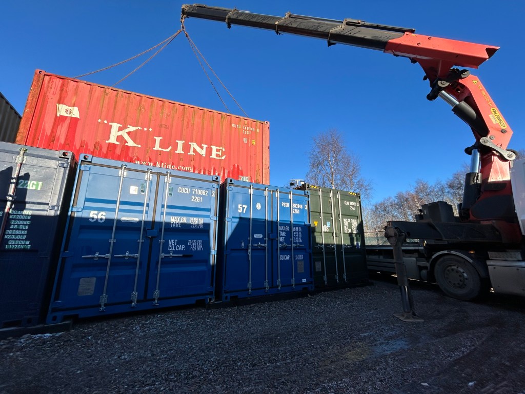 a hiab lifting a shipping container