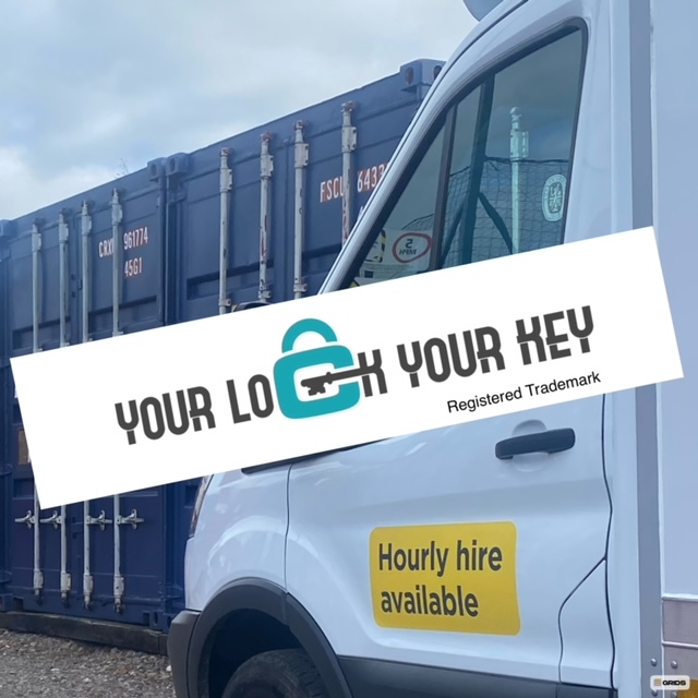 a rental van at a Your Lock Your Key self storage facility with shipping containers in the background 