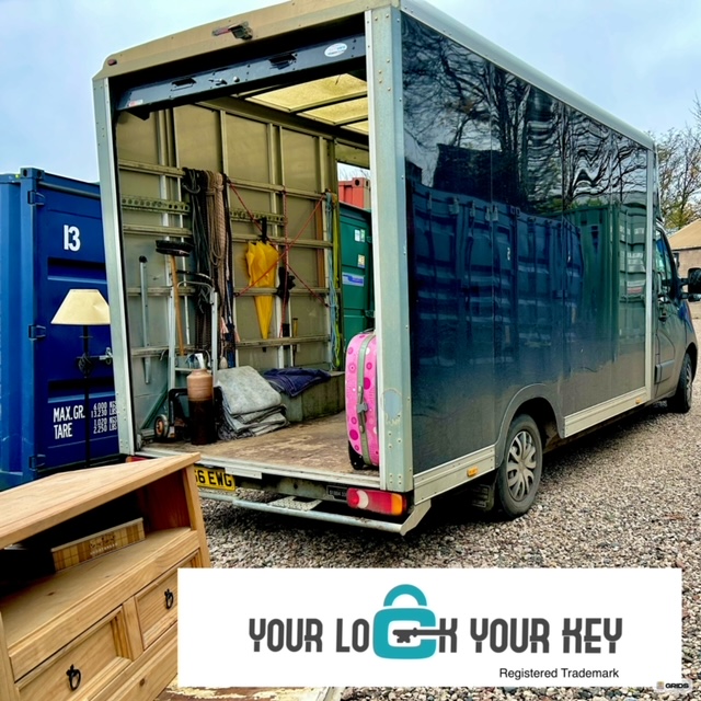 removal vehicle unloading furniture at a storage facility
