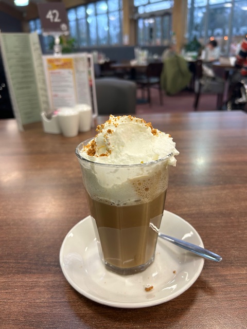  a cup of coffee in a glass on a table in Houghton Hall café premises, Carlisle, Cumbria,