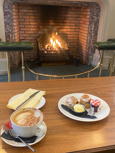 cakes on a plate with a cup of coffee