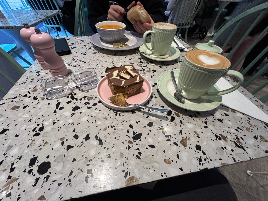 Interior Carlisle City Centre café premises showing coffee and cake on a table of the "I Love Café" premises.