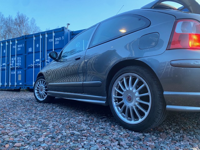 a sports car driving onto a storage facility