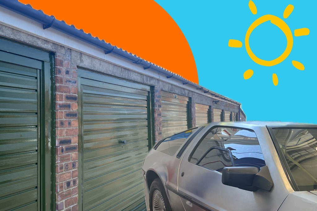 a sports car in front of a row of lock up garages