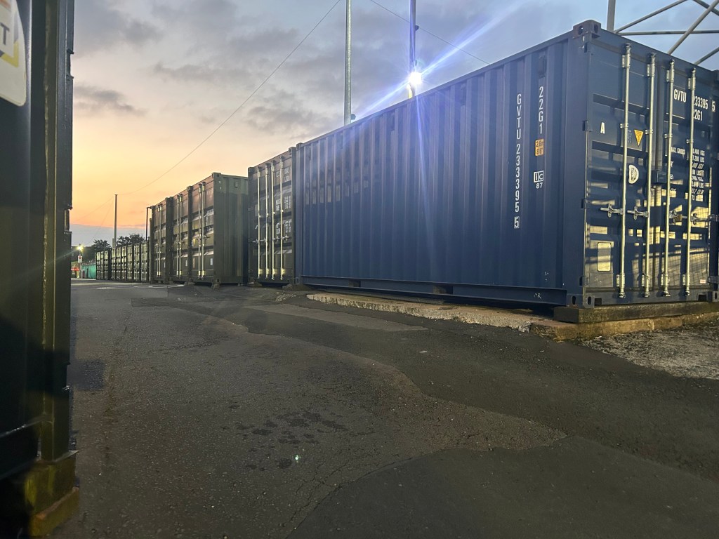 shipping containers at dusk on a self storage facility