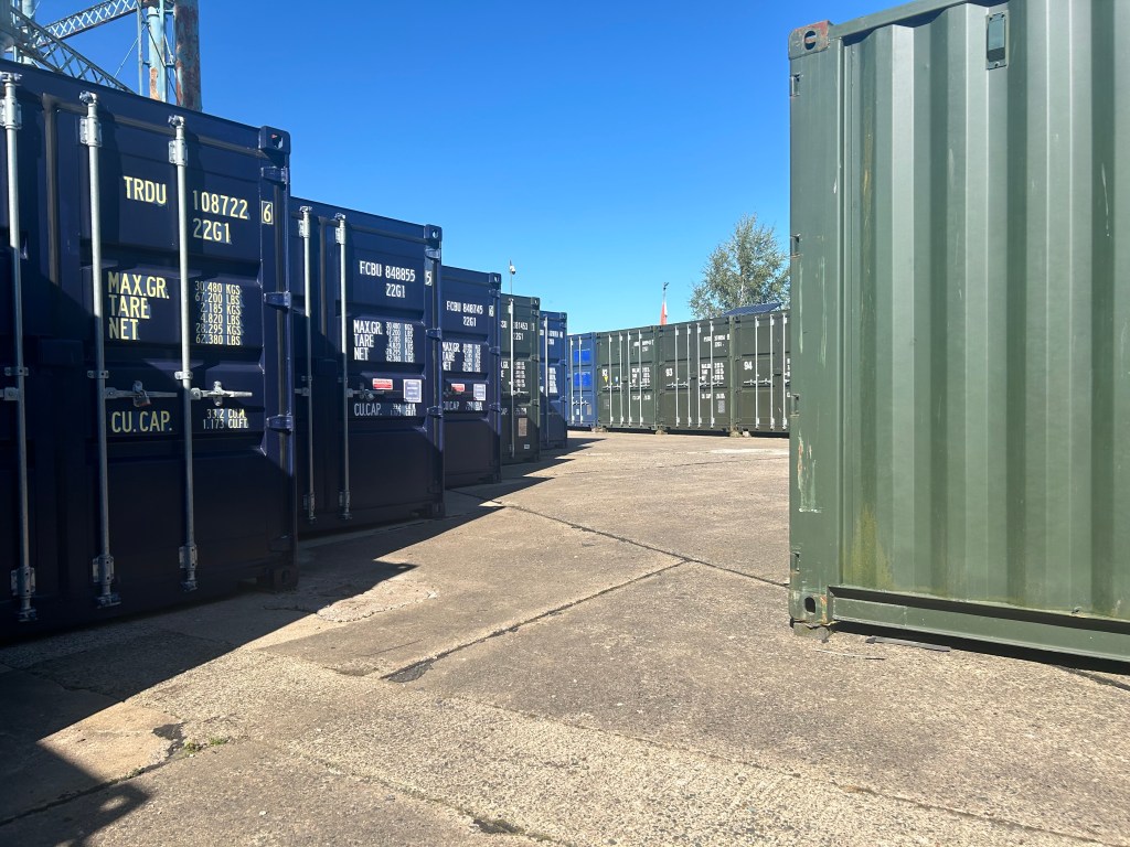 a row of shipping containers lined up neatly