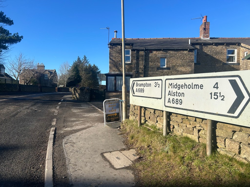 Street sign showing Brampton and Alston in Cumbria