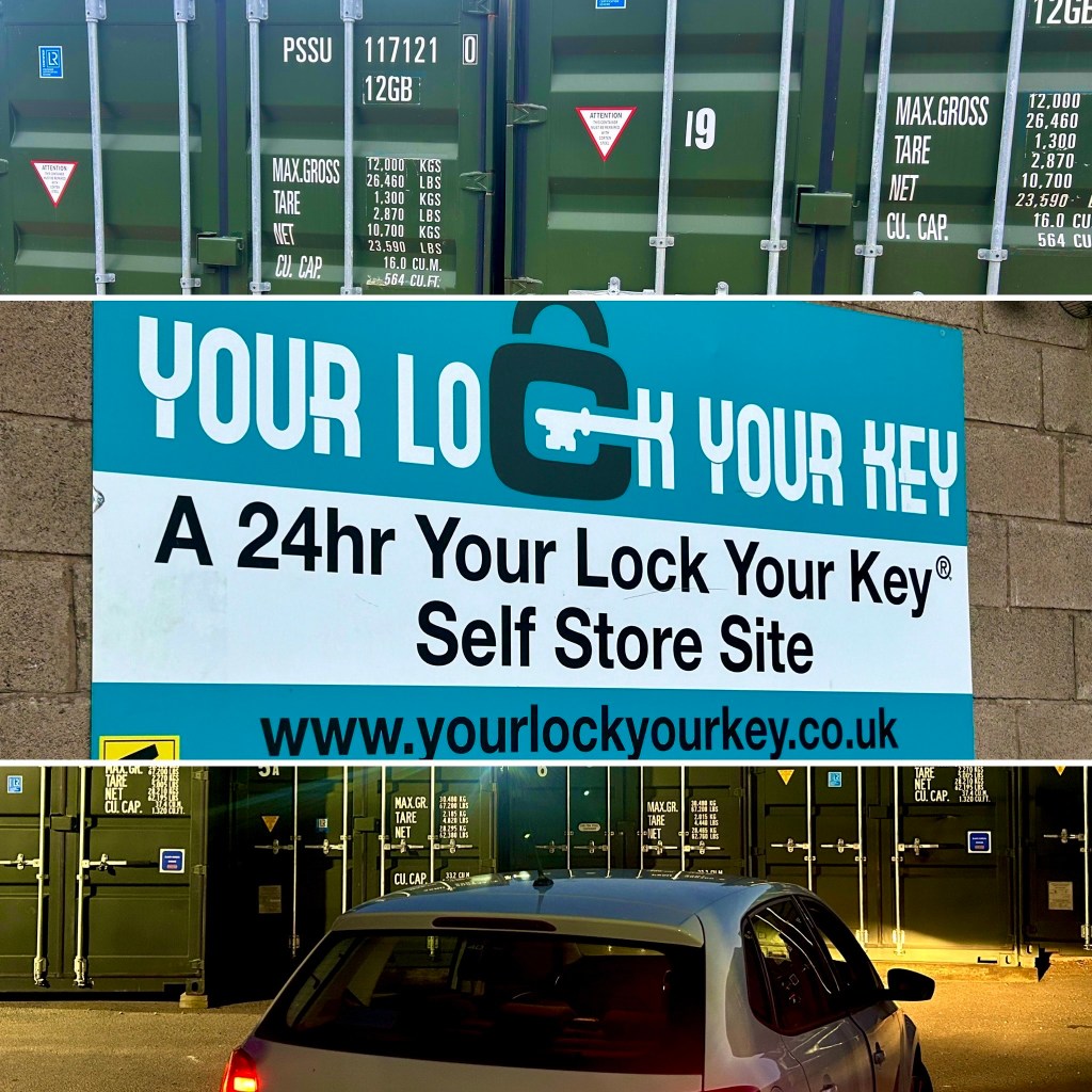 green shipping containers at night promoting the "Your Lock Your Key" company name and logo.