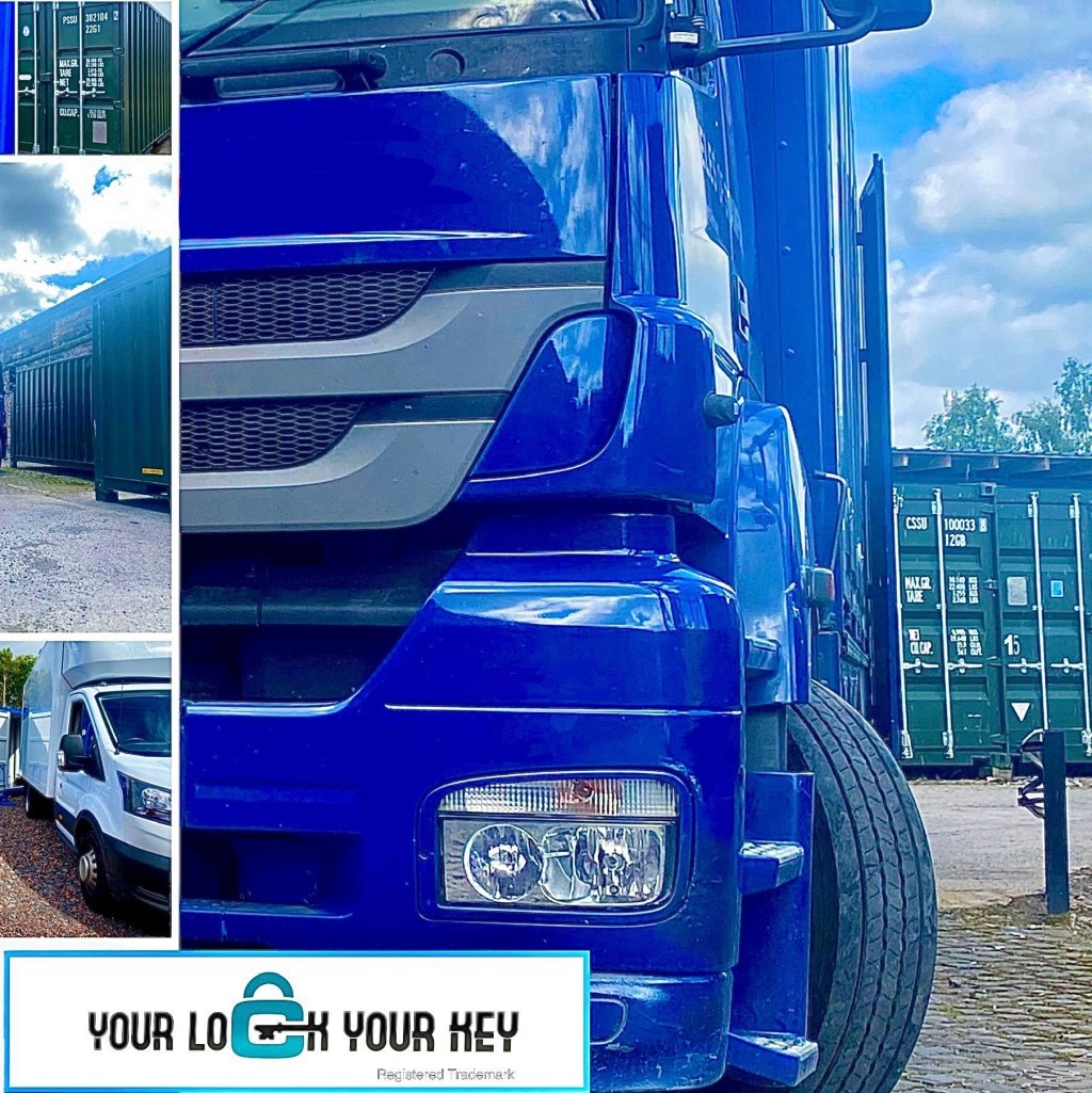 Vehicles on a self storage facility with shipping containers in the background.