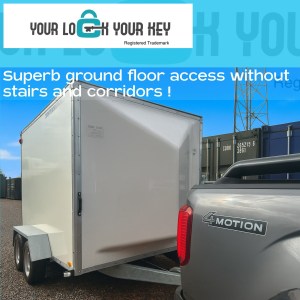 a 4x4 vehicle towing a trailer on a storage facility