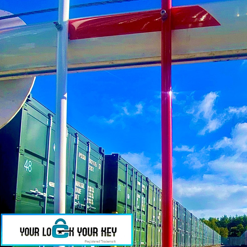 a self storage facility showing a row of shipping containers and an entry barrier