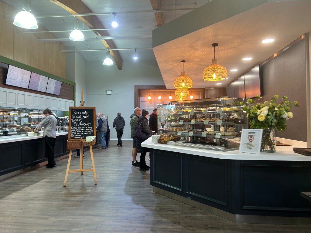 Houghton Hall  garden centre cafe entrance showing people ordering food. 