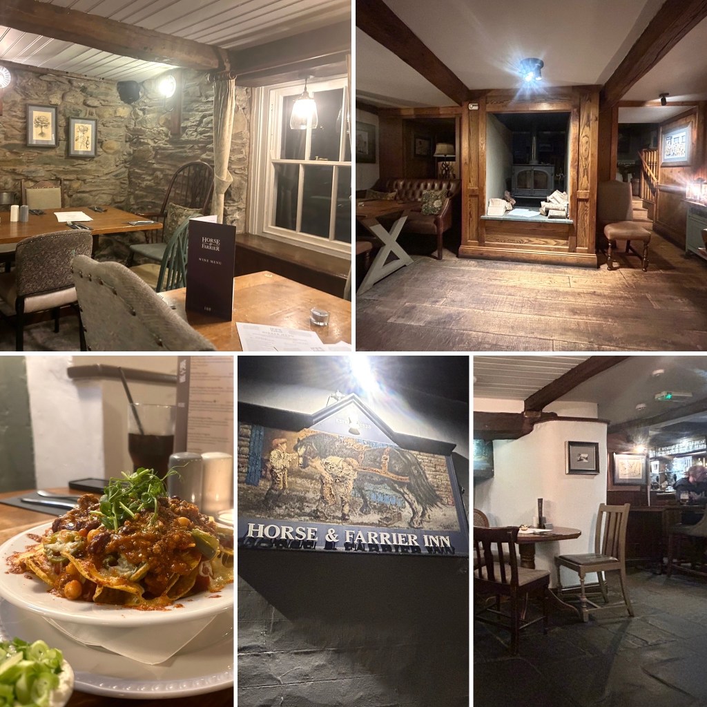 Interior view of the Horse & Farrier Inn featuring rustic wooden beams and stone walls, with tables set for dining.