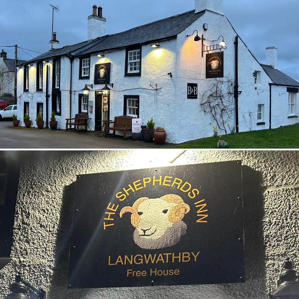 Exterior view of The Shepherds Inn, Langwathby in Cumbria, a white building with a traditional design, featuring outdoor seating and illuminated signage.