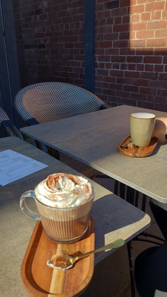 Two cups of coffee on a table at The Lounge Café in Penrith, Cumbria.