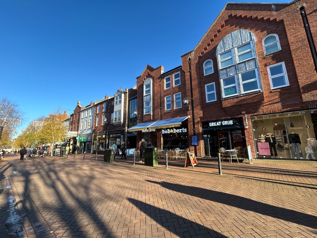 Carlisle City Centre street scene showing shops.
